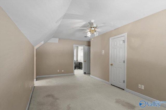 additional living space featuring vaulted ceiling, carpet floors, a ceiling fan, and baseboards