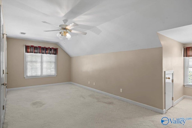 bonus room featuring ceiling fan, vaulted ceiling, a healthy amount of sunlight, and visible vents