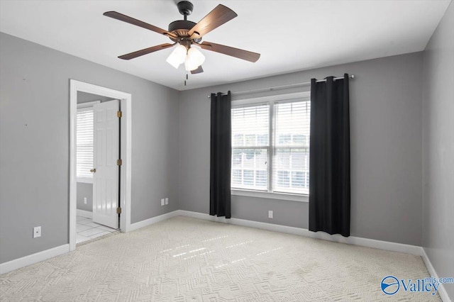 spare room featuring baseboards, a ceiling fan, and carpet flooring