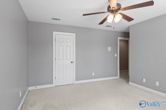 unfurnished bedroom featuring carpet floors, visible vents, a ceiling fan, and baseboards