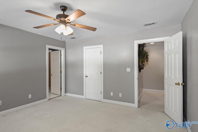 unfurnished bedroom featuring baseboards, a ceiling fan, visible vents, and carpet floors