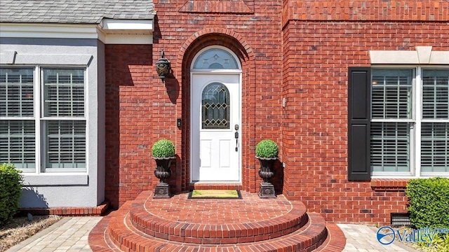 entrance to property with brick siding