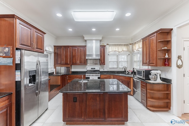 kitchen featuring appliances with stainless steel finishes, crown molding, sink, wall chimney range hood, and a center island