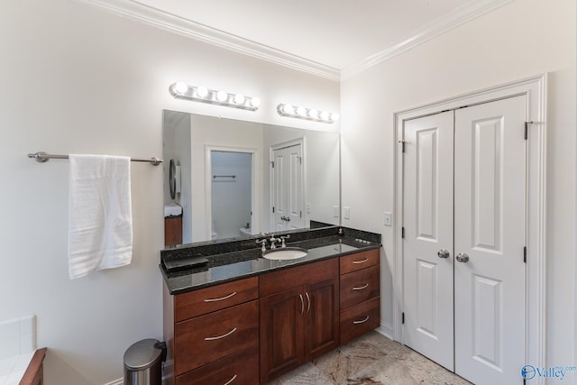 bathroom featuring vanity, toilet, and ornamental molding