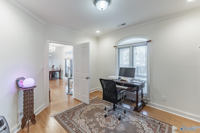 office space featuring ornamental molding, a notable chandelier, and hardwood / wood-style flooring