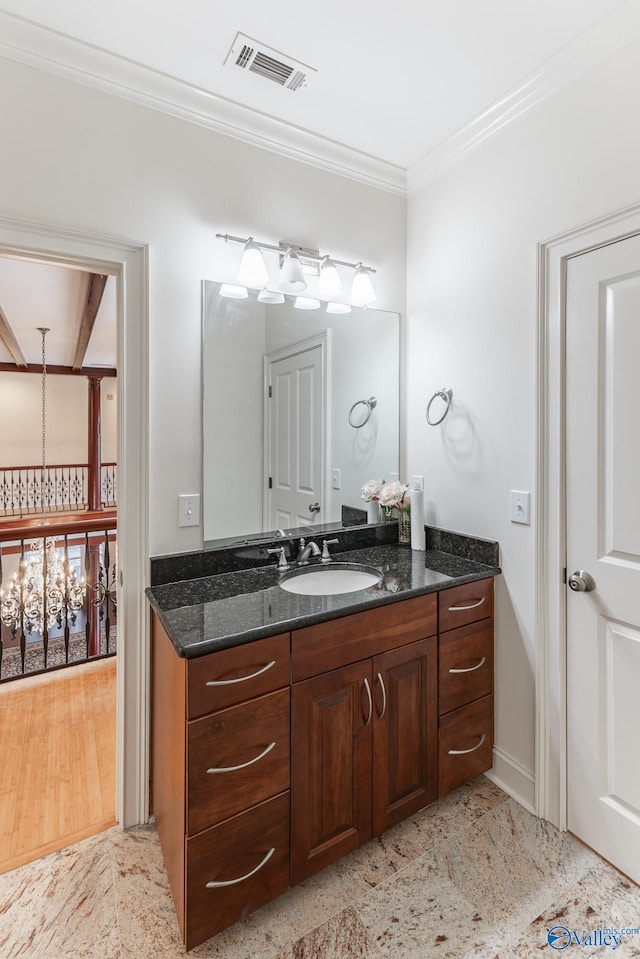 bathroom featuring vanity, ornamental molding, and a chandelier