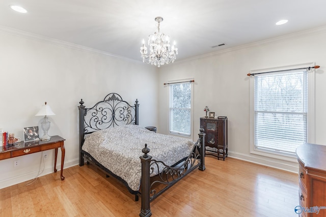 bedroom featuring hardwood / wood-style floors, crown molding, multiple windows, and a notable chandelier
