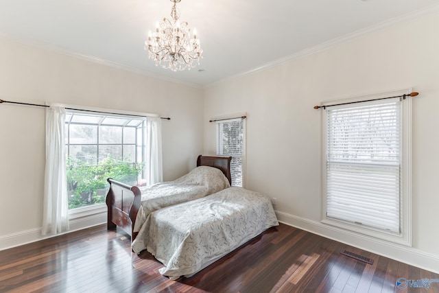 bedroom with multiple windows, dark wood-type flooring, and a chandelier