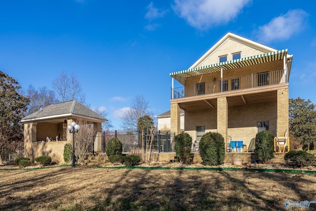 rear view of property with a balcony