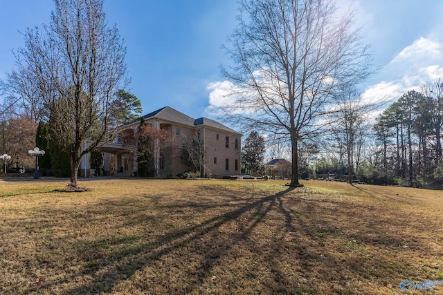 view of home's exterior with a lawn