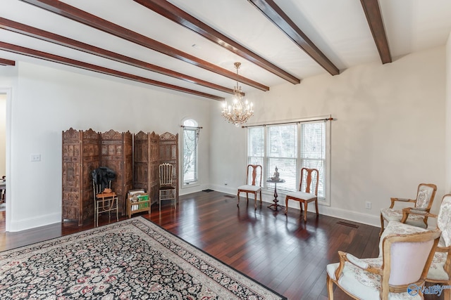 living area with beamed ceiling, a chandelier, and dark hardwood / wood-style floors