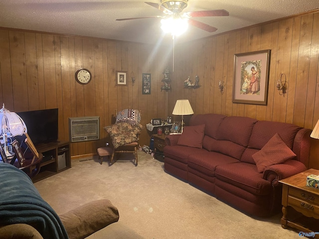 carpeted living room with ceiling fan and a textured ceiling