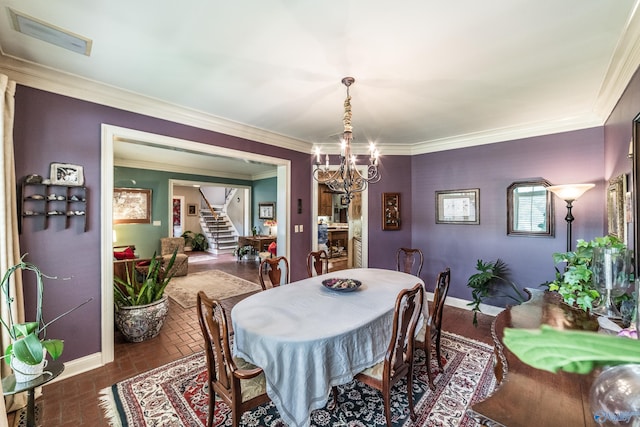 dining area with ornamental molding and an inviting chandelier