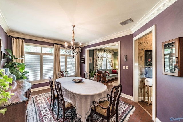 dining room with crown molding and a chandelier