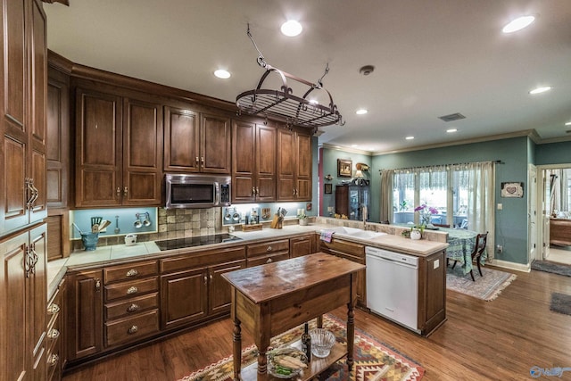 kitchen with crown molding, black electric stovetop, tile countertops, and white dishwasher