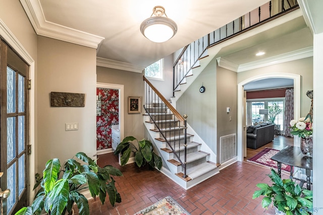 staircase featuring crown molding