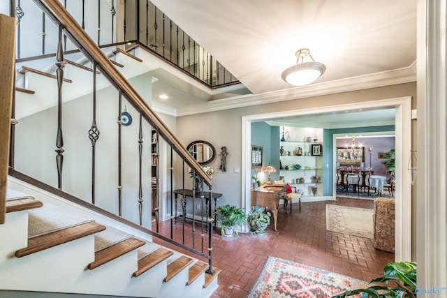 interior space with crown molding and a notable chandelier