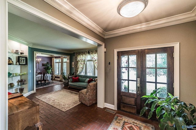 doorway with crown molding and french doors