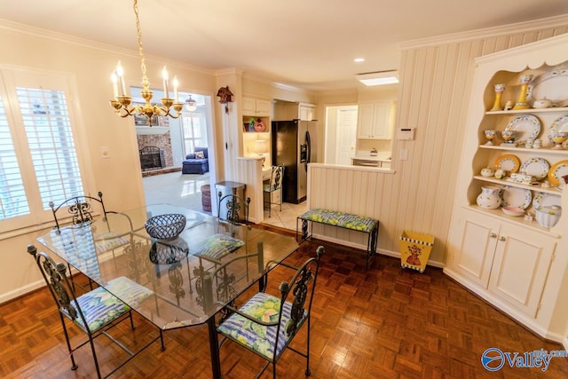 dining area featuring dark parquet floors, crown molding, and a fireplace