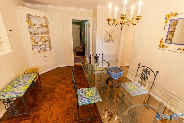 dining area with crown molding, dark parquet floors, and an inviting chandelier