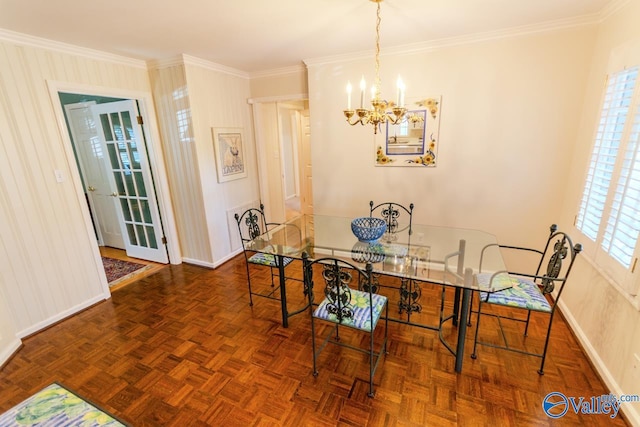 dining space featuring a wealth of natural light, dark parquet floors, an inviting chandelier, and ornamental molding