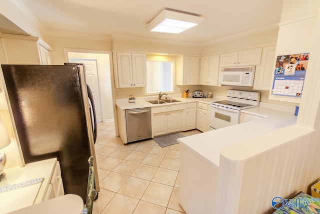 kitchen with white appliances, crown molding, sink, light tile patterned floors, and white cabinetry