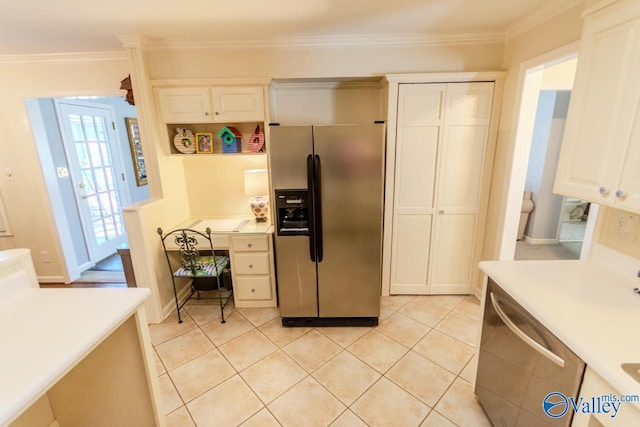 kitchen with crown molding, light tile patterned floors, and appliances with stainless steel finishes