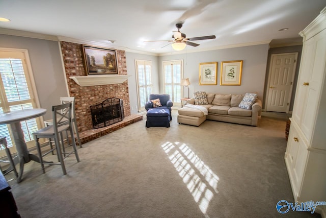 living room featuring ornamental molding, a brick fireplace, ceiling fan, and a healthy amount of sunlight