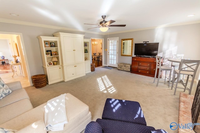 carpeted living room with ceiling fan and ornamental molding