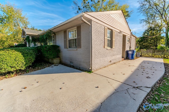 view of side of home with a patio area