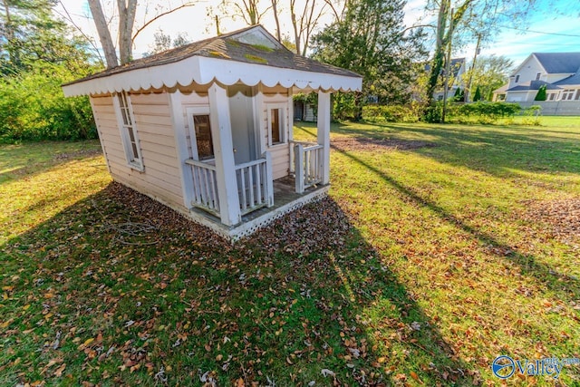 view of outbuilding featuring a lawn