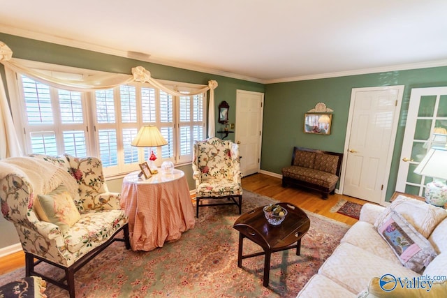 living room with wood-type flooring and ornamental molding