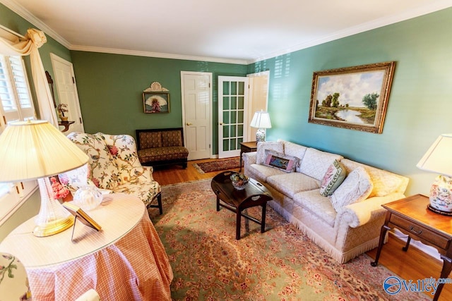 living room with hardwood / wood-style flooring and crown molding