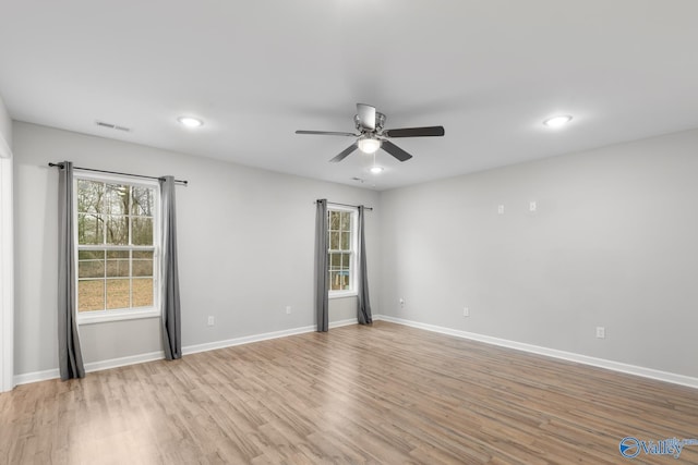 spare room featuring ceiling fan and light hardwood / wood-style flooring