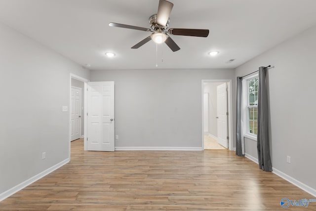 spare room with light wood-type flooring and ceiling fan