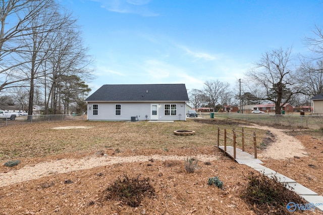 exterior space featuring an outdoor fire pit and a lawn