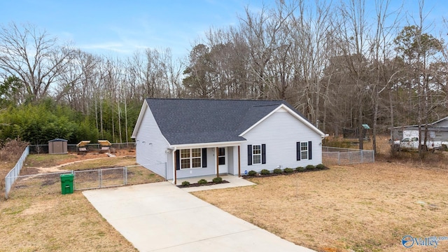 view of front facade featuring a front yard, a porch, and a shed