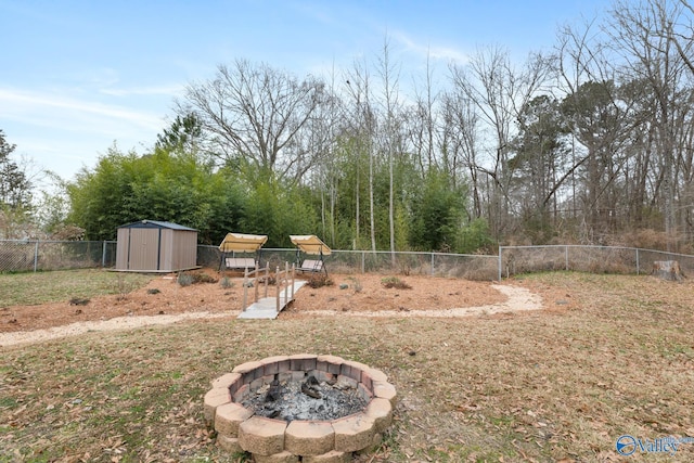 view of yard with an outdoor fire pit and a shed