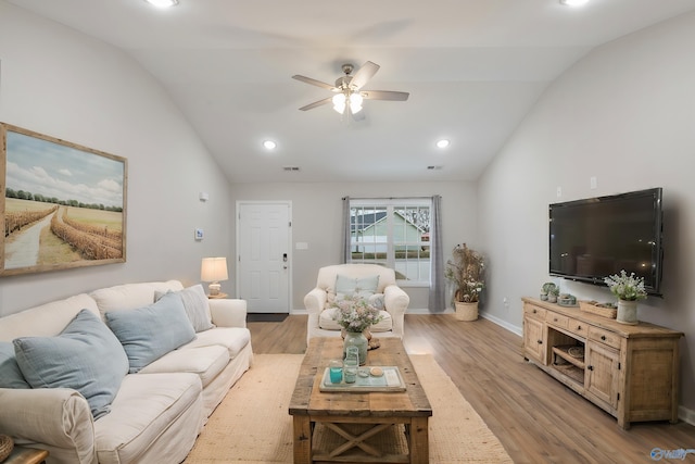 living room with ceiling fan, lofted ceiling, and light wood-type flooring