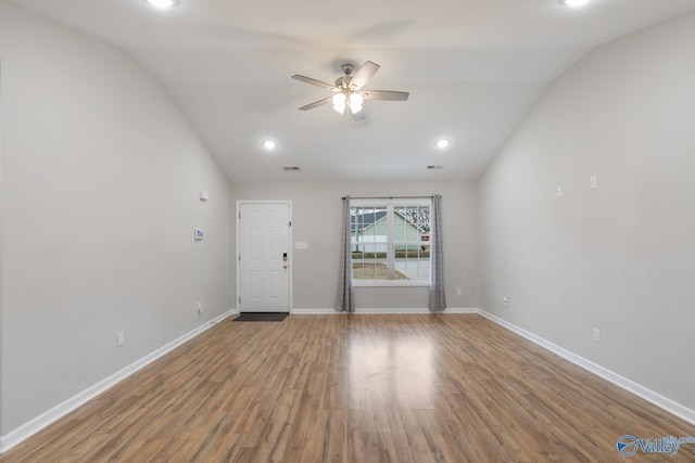 empty room with ceiling fan, hardwood / wood-style flooring, and lofted ceiling