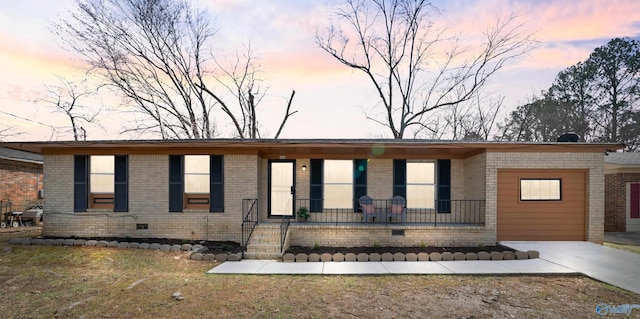 ranch-style house featuring a porch, crawl space, and brick siding