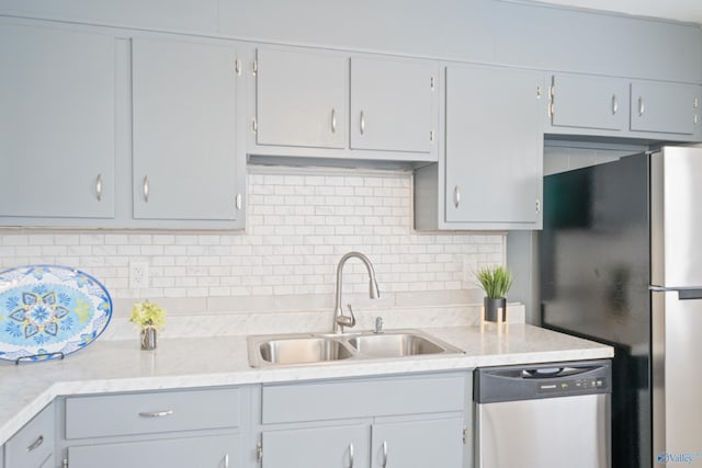 kitchen with stainless steel appliances, tasteful backsplash, and a sink