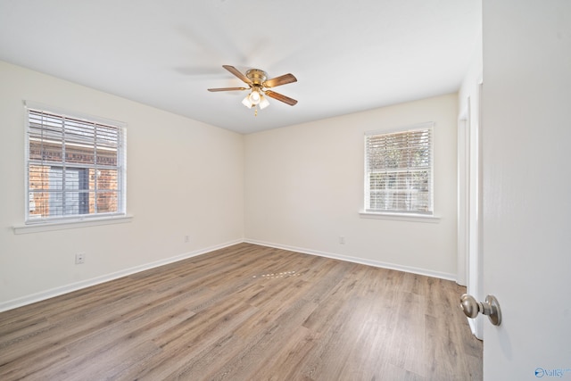 unfurnished room with light wood-style floors, ceiling fan, and baseboards