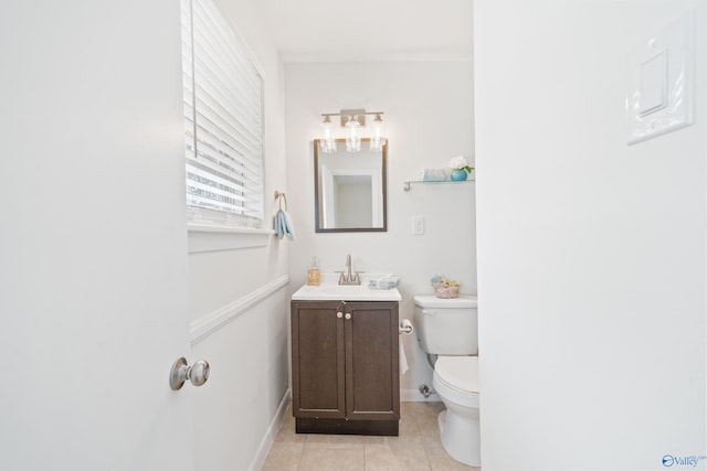 bathroom with toilet, tile patterned flooring, baseboards, and vanity