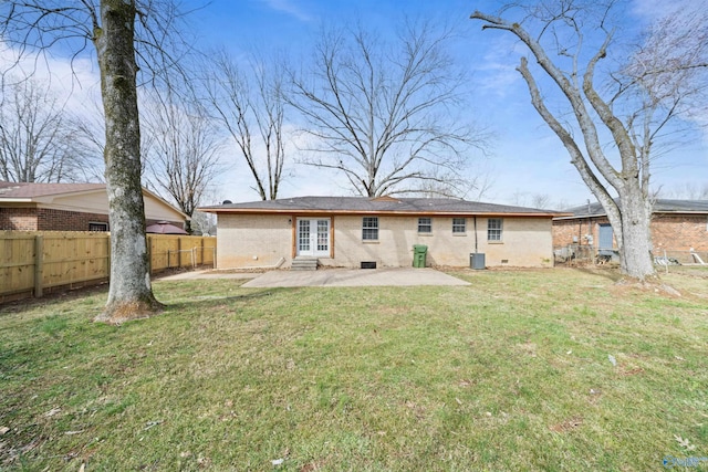 rear view of property featuring french doors, a yard, crawl space, a patio area, and fence