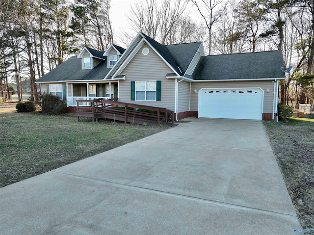 view of front of property featuring a garage, a porch, and a front lawn