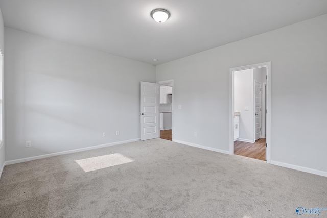 unfurnished bedroom with light carpet and baseboards