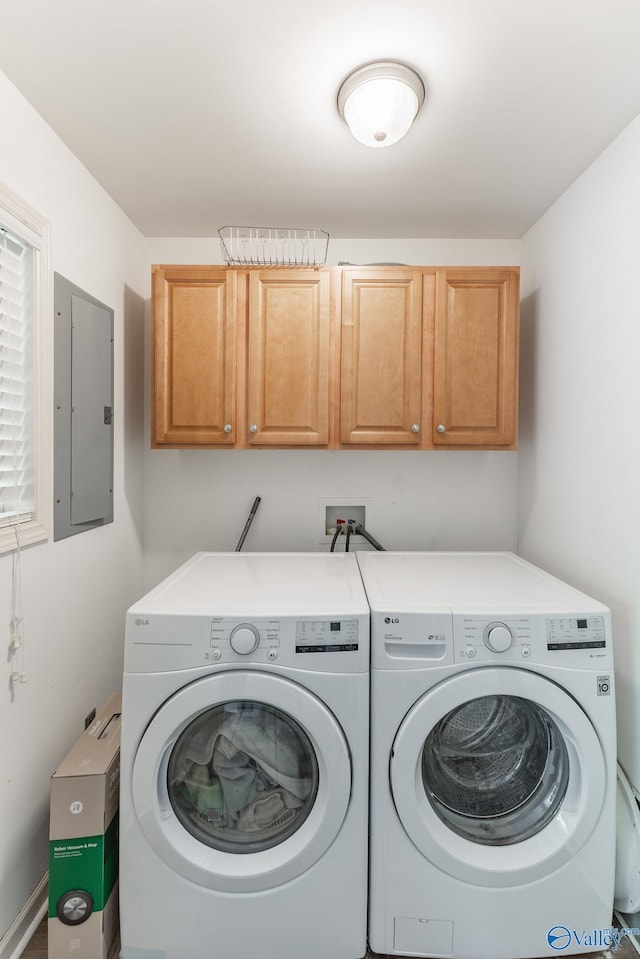 laundry area with cabinets, electric panel, and washing machine and dryer