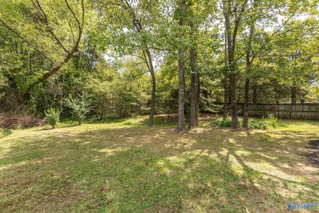 single story home with driveway, a front yard, brick siding, and a garage