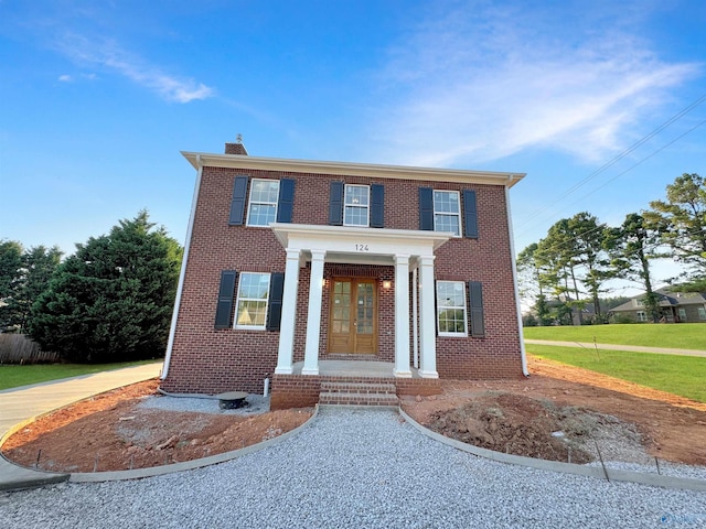 view of front of home featuring a front lawn and covered porch